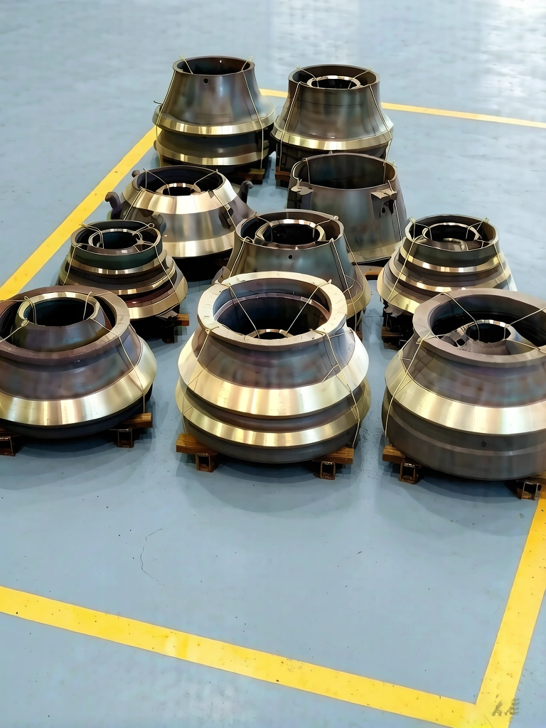 Heavy-duty manganese steel crusher mantles and concaves in manufacturing warehouse